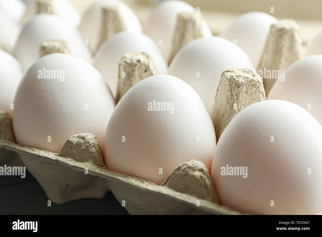 White chicken eggs in carton box on wooden table, closeup Stock Photo ...