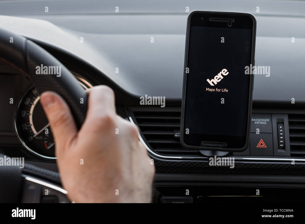 LOS ANGELES, CALIFORNIA - JUNE 6, 2019: Close up to male driving and using navigation appliction HERE WeGo. An illustrative editorial image. Stock Photo