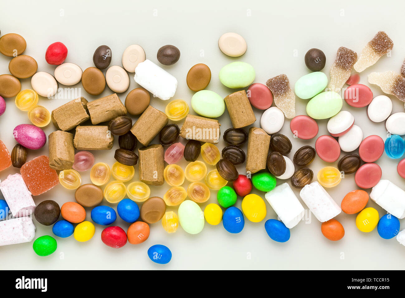 multicolored caramel candies scattered on the table background. sugar products. colored sweets Stock Photo