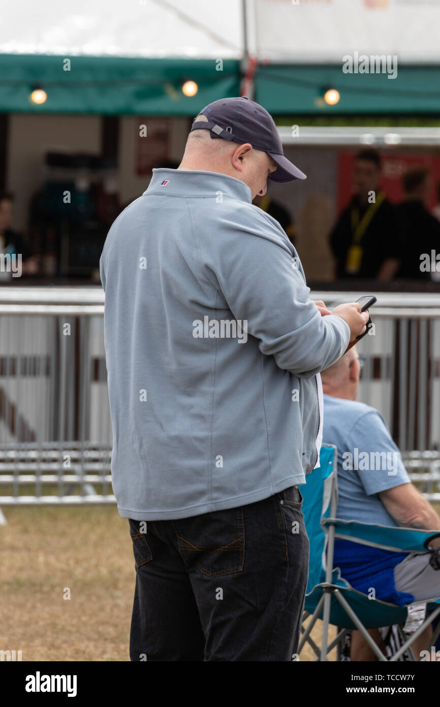 A man using a mobile phone or a cell phone Stock Photo