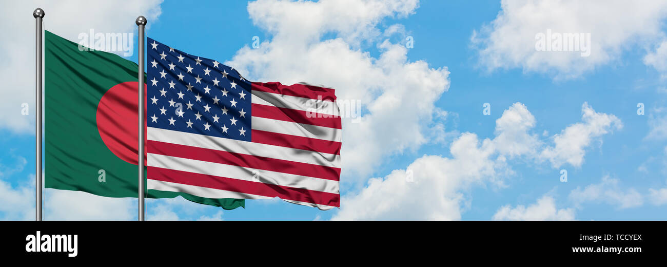 Bangladesh and United States flag waving in the wind against white cloudy blue sky together. Diplomacy concept, international relations. Stock Photo