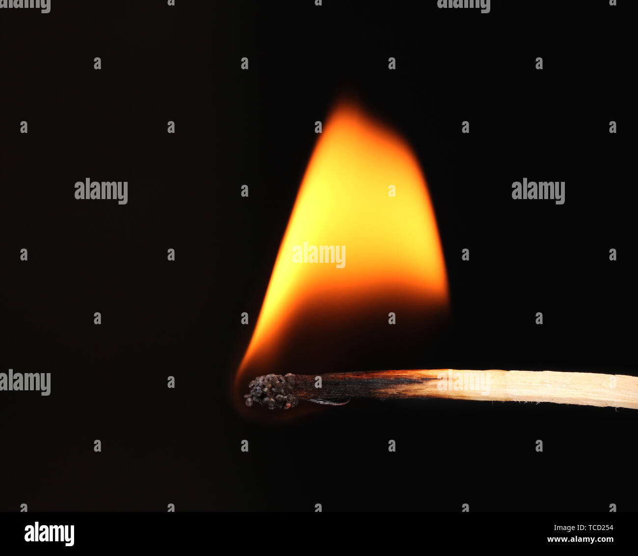 Burning match on black background Stock Photo - Alamy
