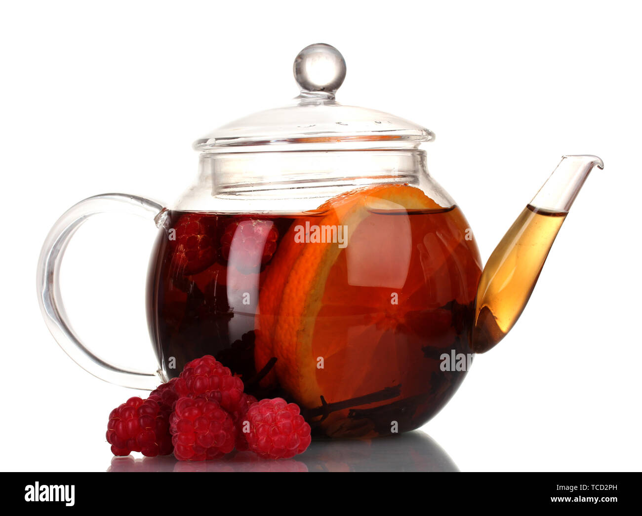 Glass teapot with black tea of raspberries and orange isolated on white ...