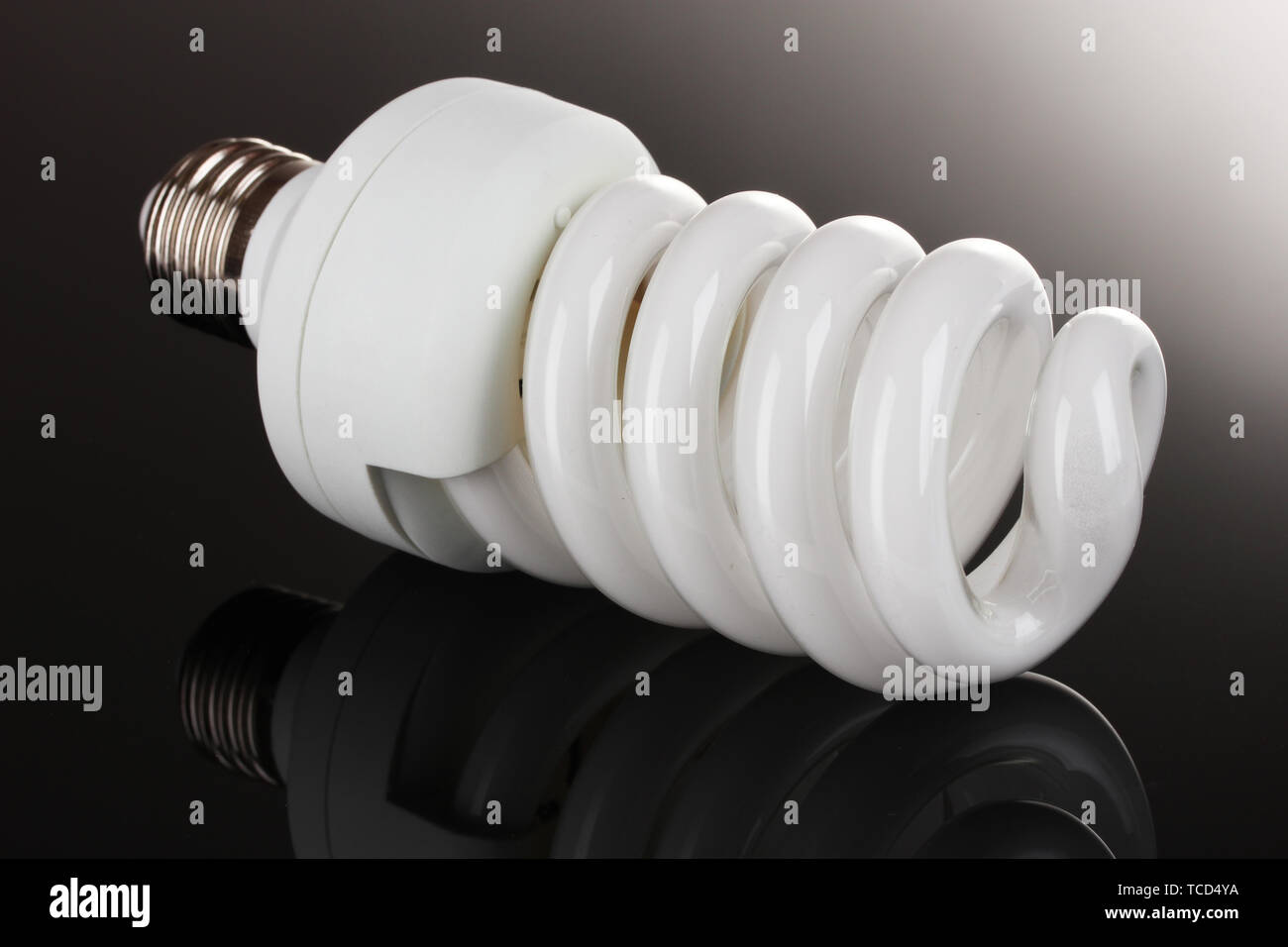 energy saving light bulb on black background Stock Photo - Alamy