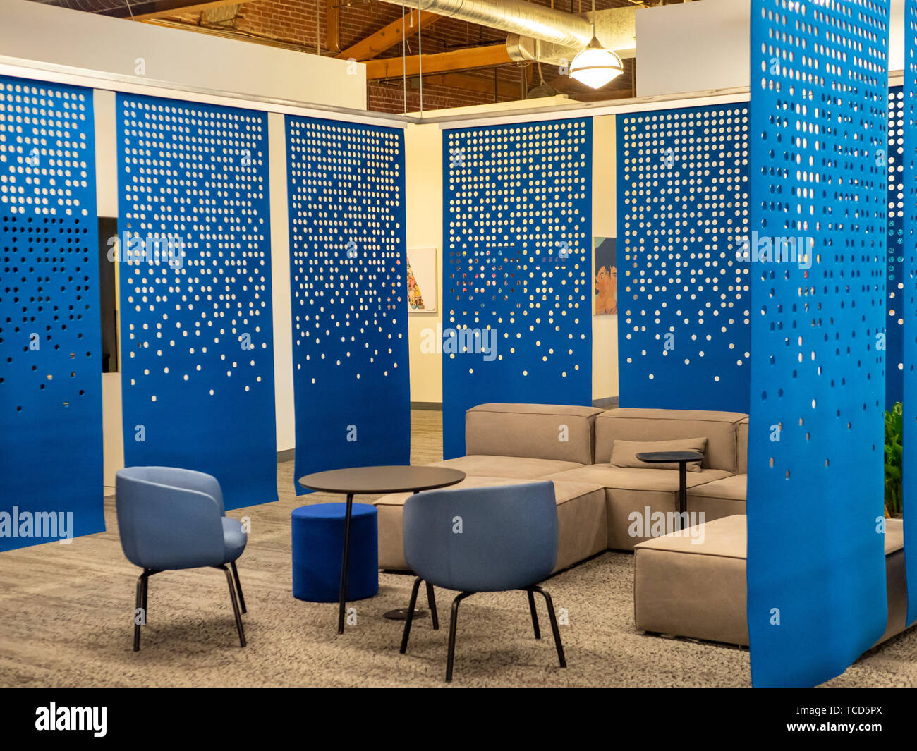 Modern office environment with some felt blue dividers and lounging