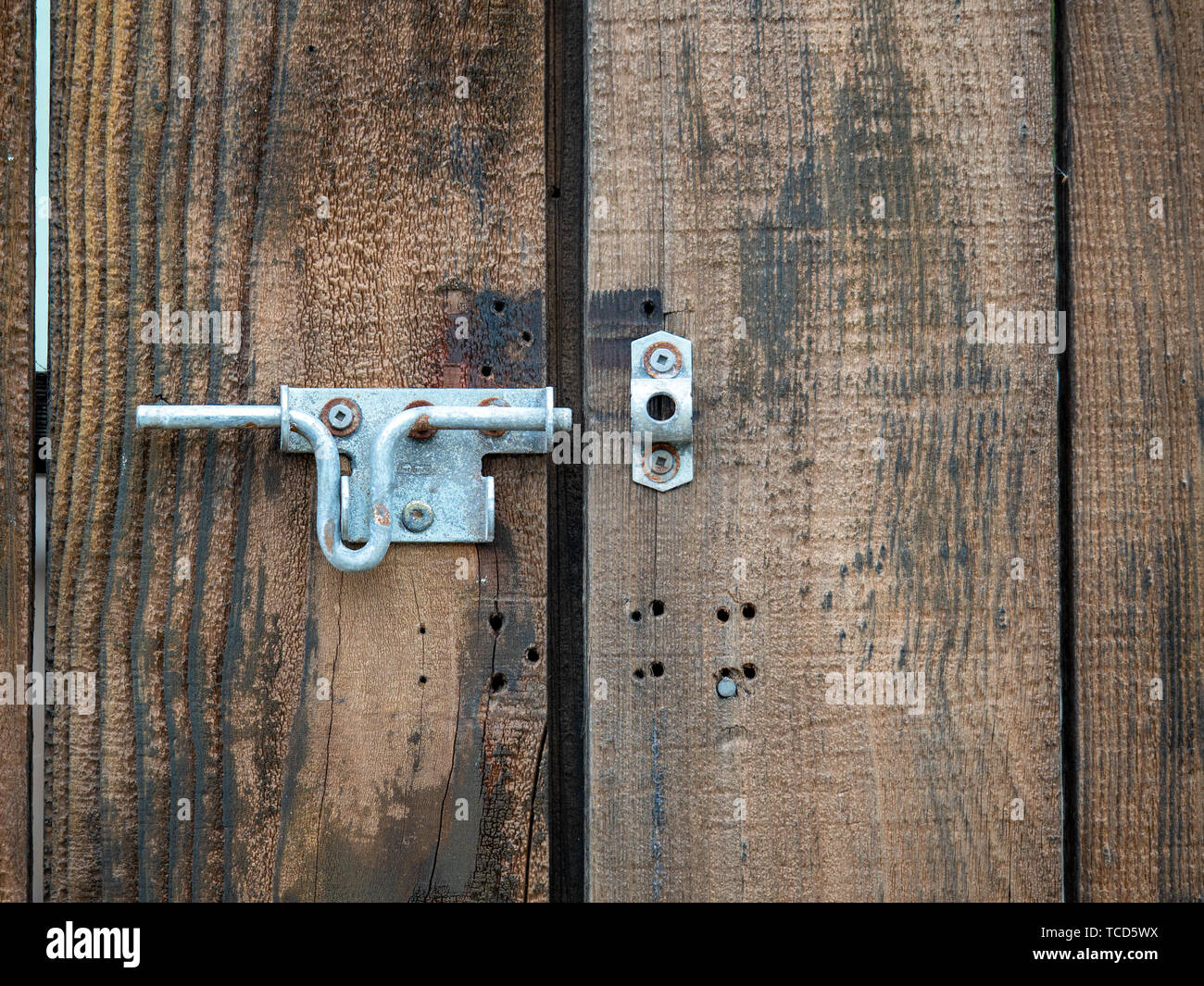 Wooden Double Door Of Entrance With An Open Metal Latch Lock Stock