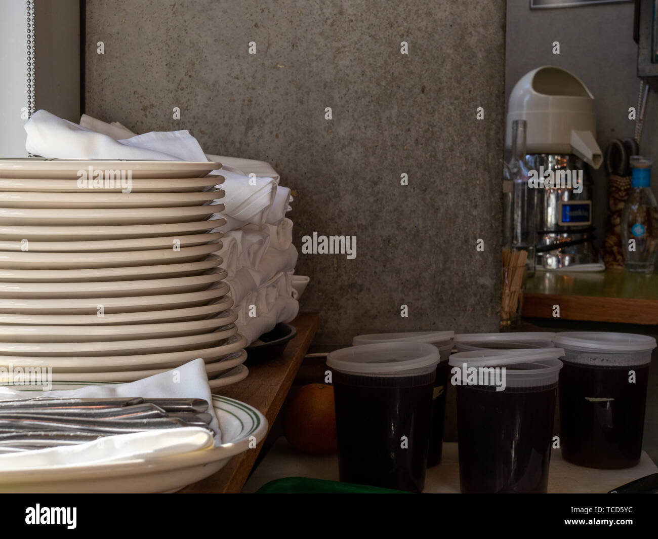 Plates, utensils, napkins, drink mix materials behind bar Stock Photo