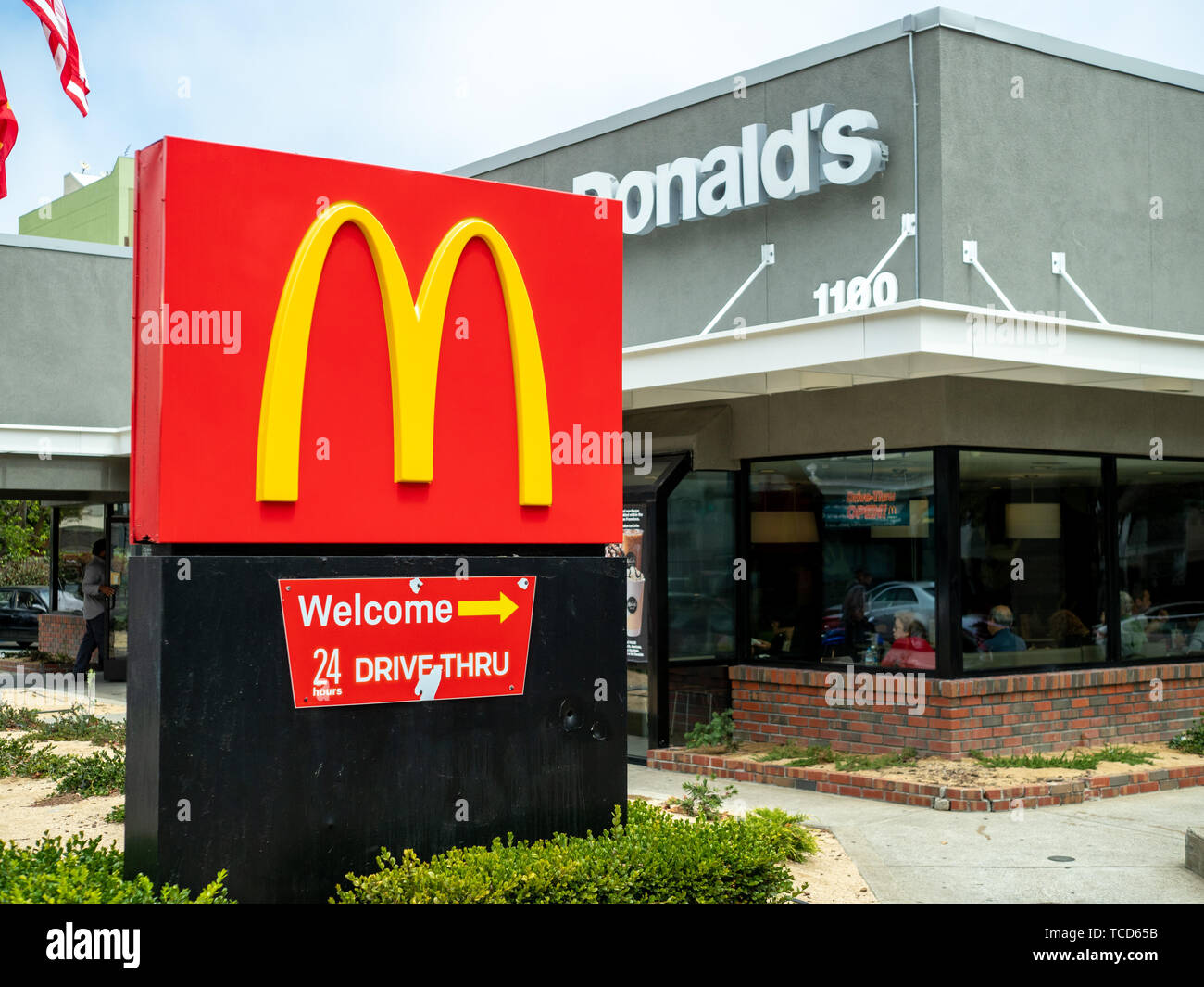 McDonalds logo, restaurant location and 24 hour drive through sign outside of remodeled location Stock Photo