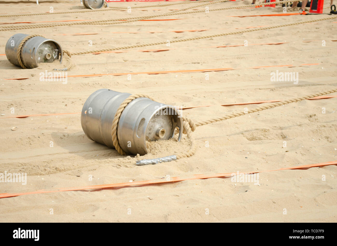 Sports competition with a barrel and a rope on the beach. Stock Photo