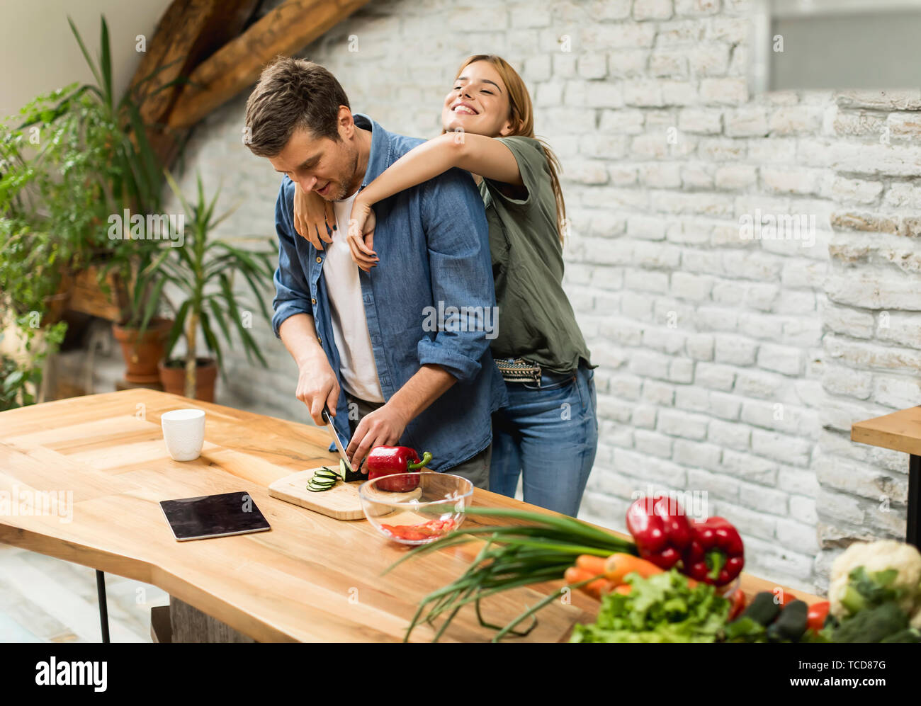 Lovely couple preparing food  in the kitchen Stock Photo