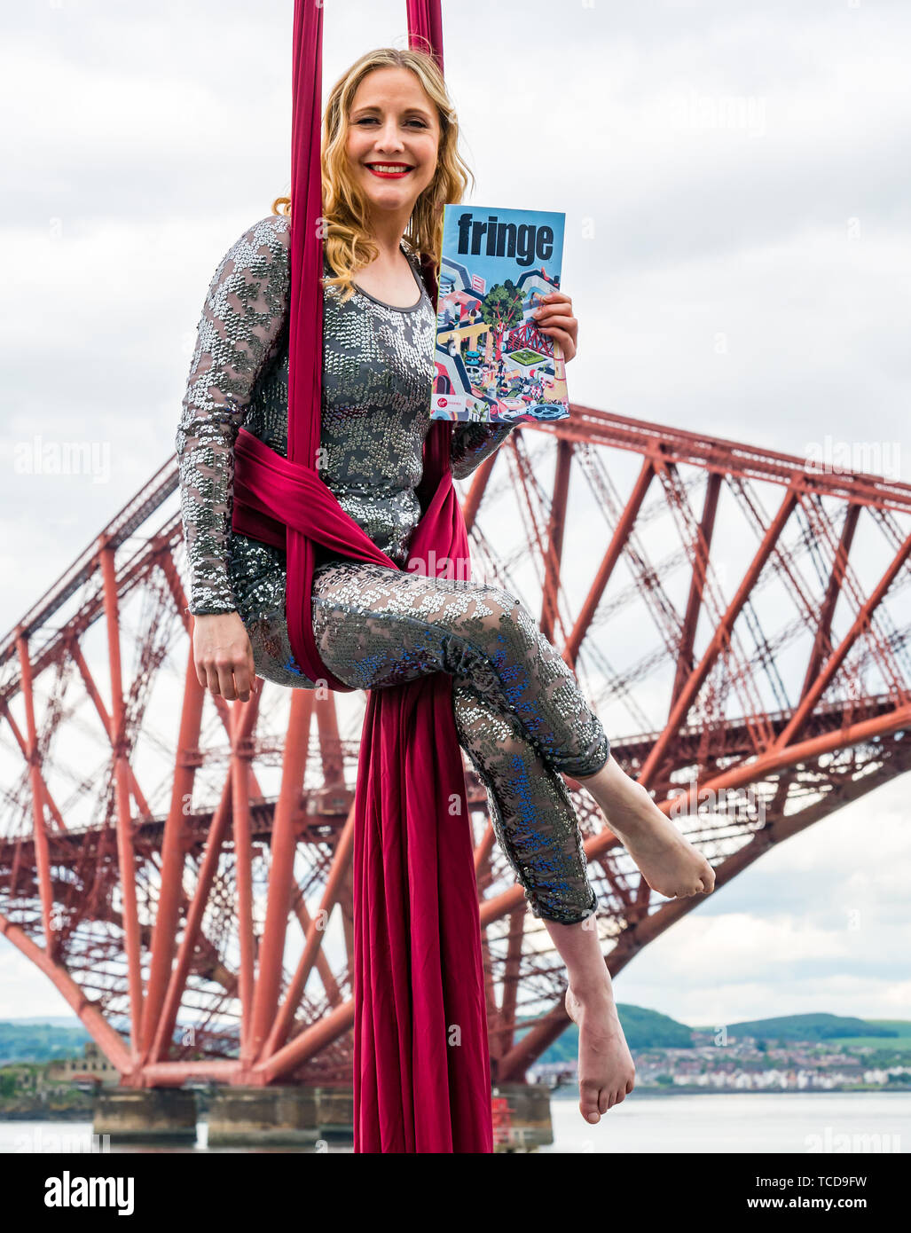 Aerial artist, Blaise Donald performs by the iconic Forth Rail Bridge launching Edinburgh Festival Fringe programme, South Queensferry, Scotland, UK Stock Photo