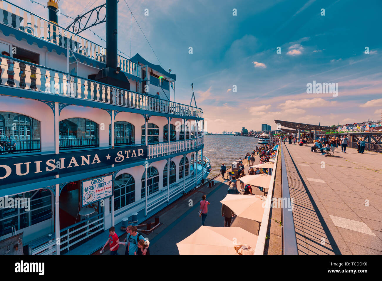 HAMBURG, GERMANY - June 01, 2019: Tourist stroll along the harbor promenade and try to catch one of the tourist boats for the next tour Stock Photo