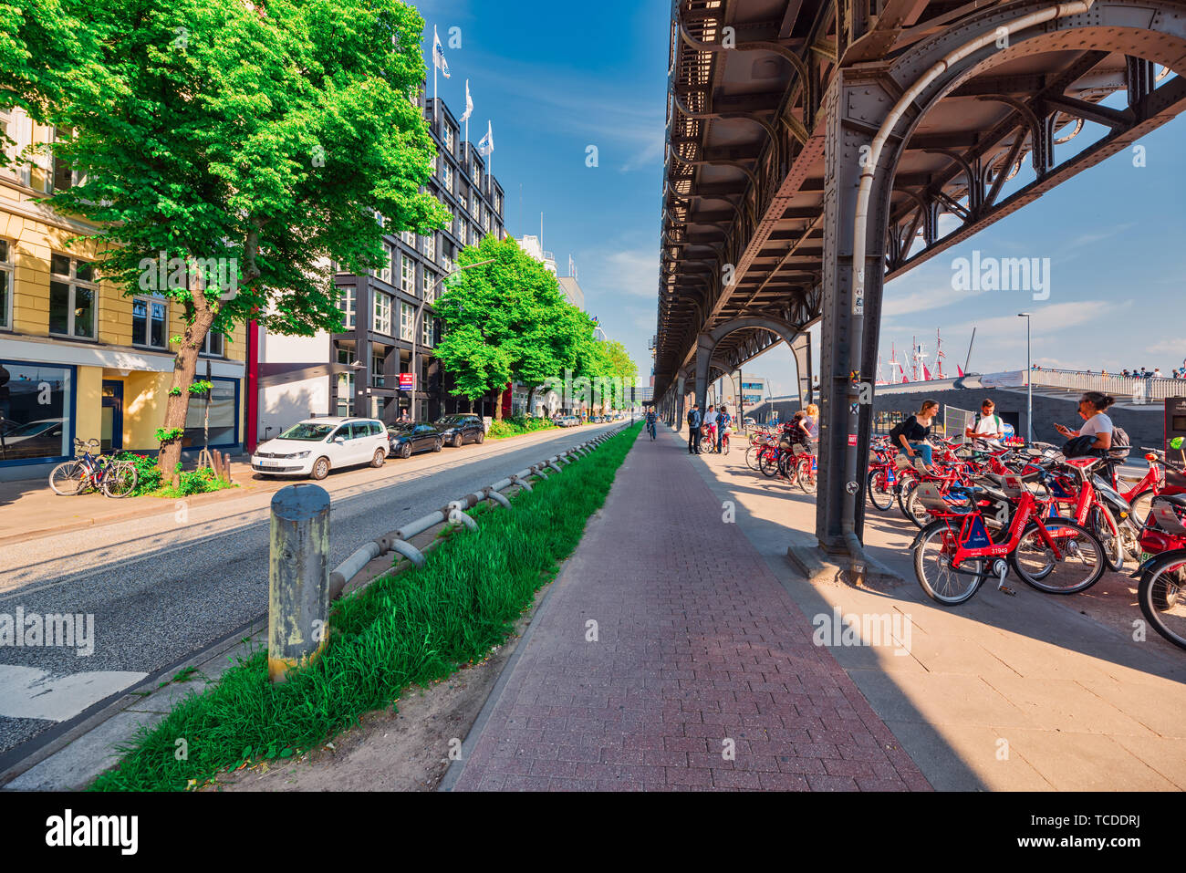 HAMBURG, GERMANY - June 01, 2019: A large bicycle station is located directly under the overhead railway station Elbphilharmonie and offers seamless m Stock Photo