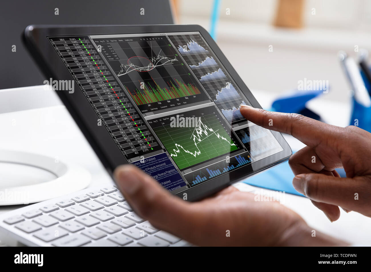Close-up Of A Businessperson Pointing On Stock Chart Over The Tablet ...