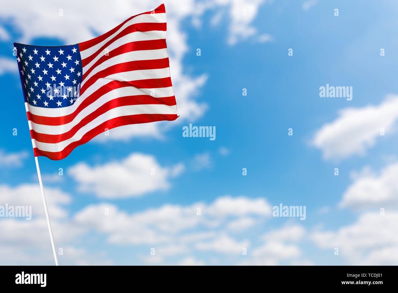 American flag against blue sky Stock Photo - Alamy