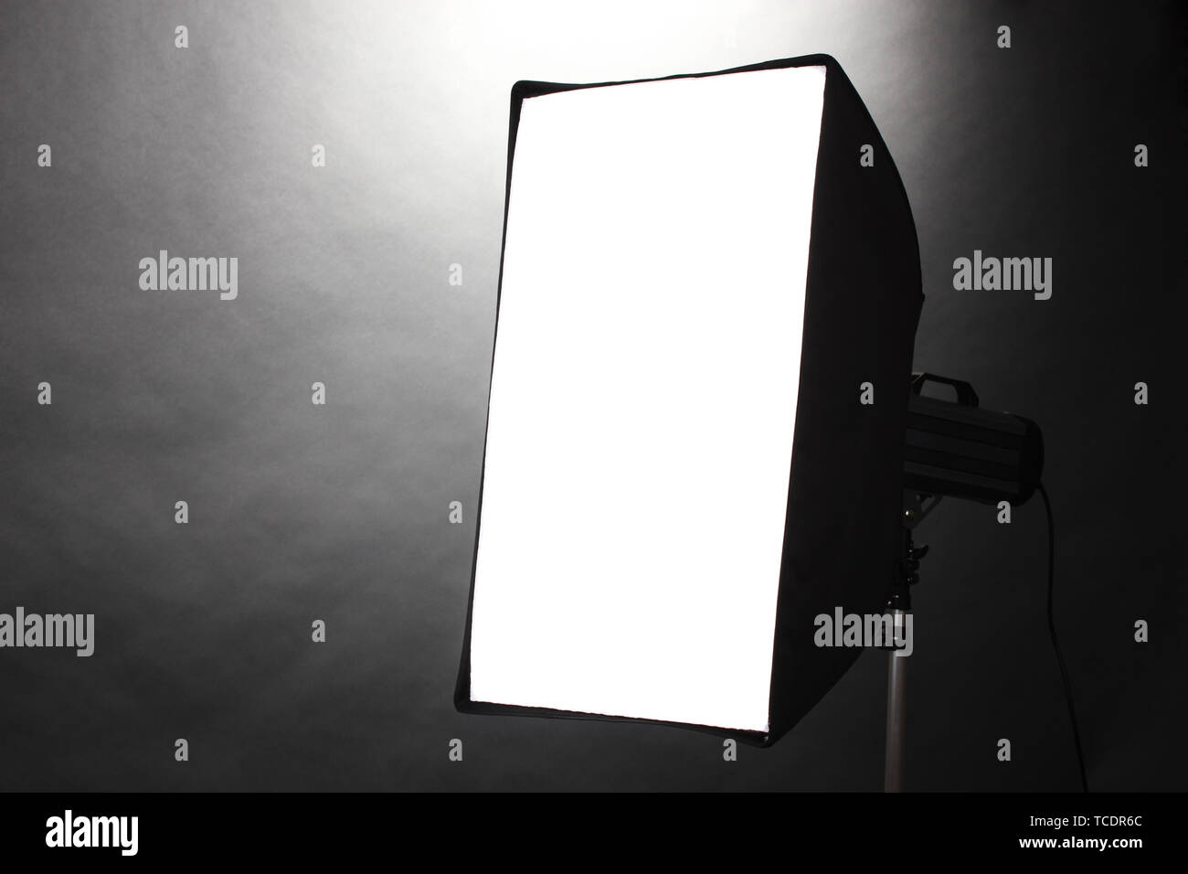 Studio flash with soft-box on grey background Stock Photo - Alamy