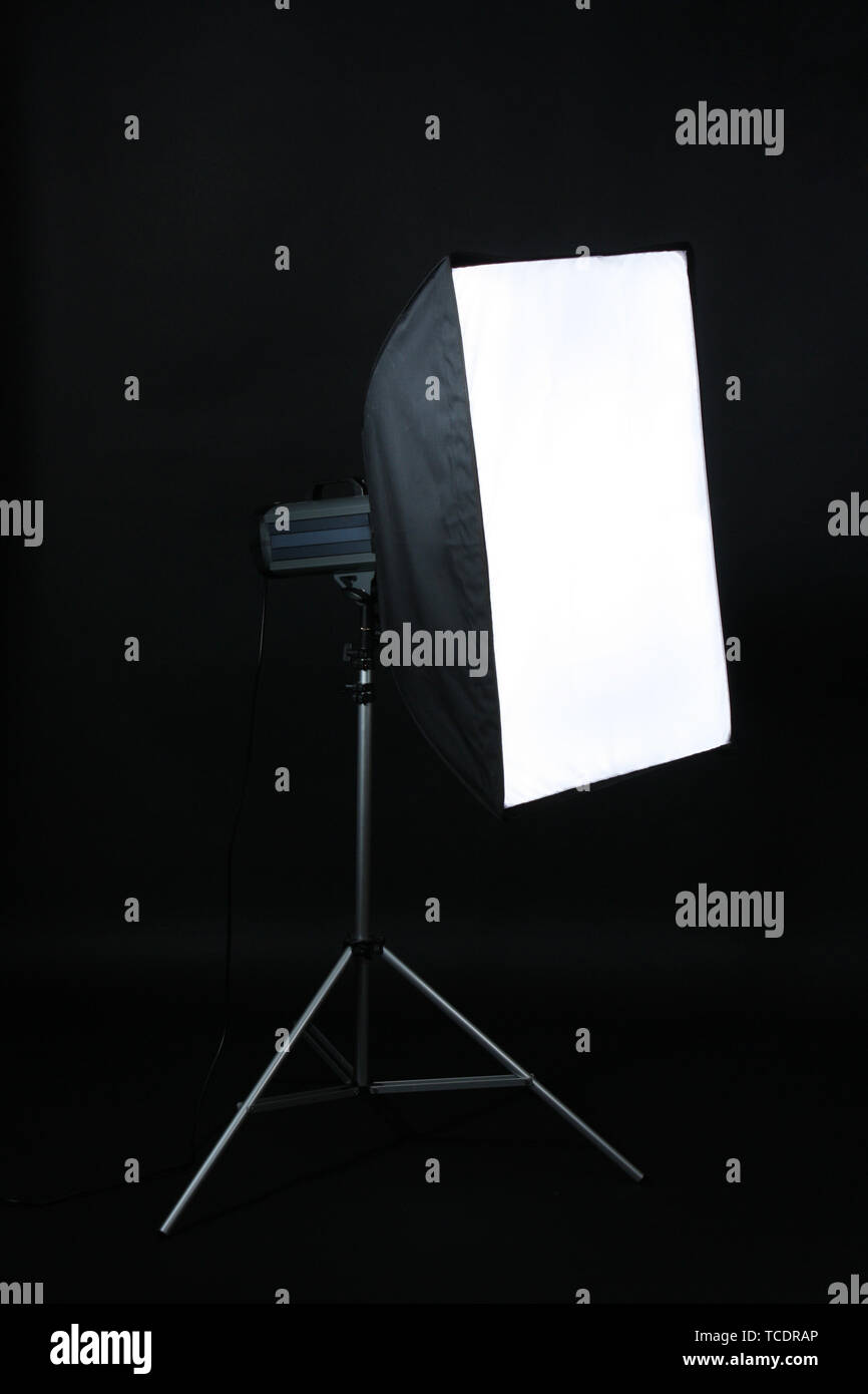 Studio flash with soft-box on black studio background Stock Photo - Alamy