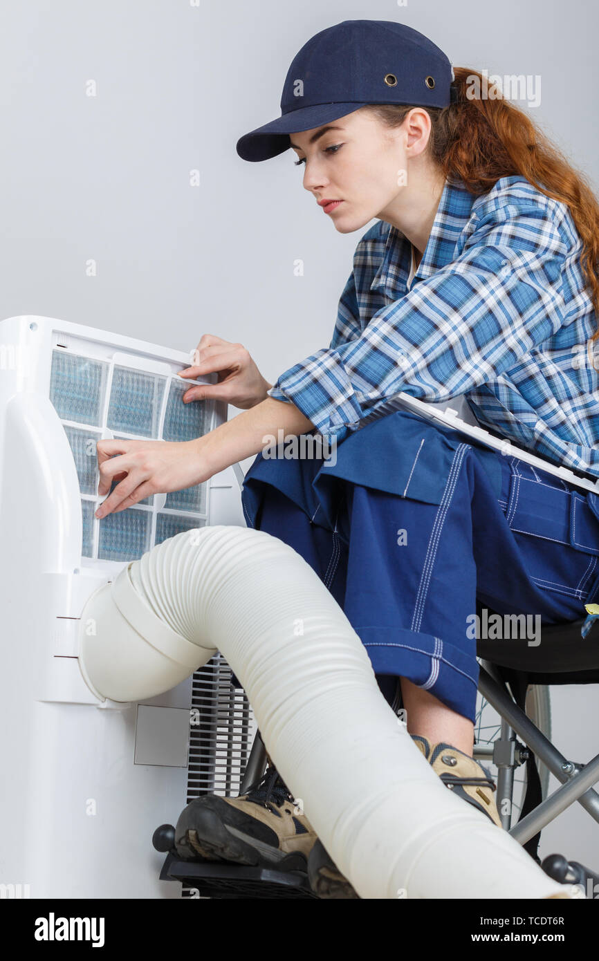 female apprentice in wheelchair fixing radiator Stock Photo - Alamy
