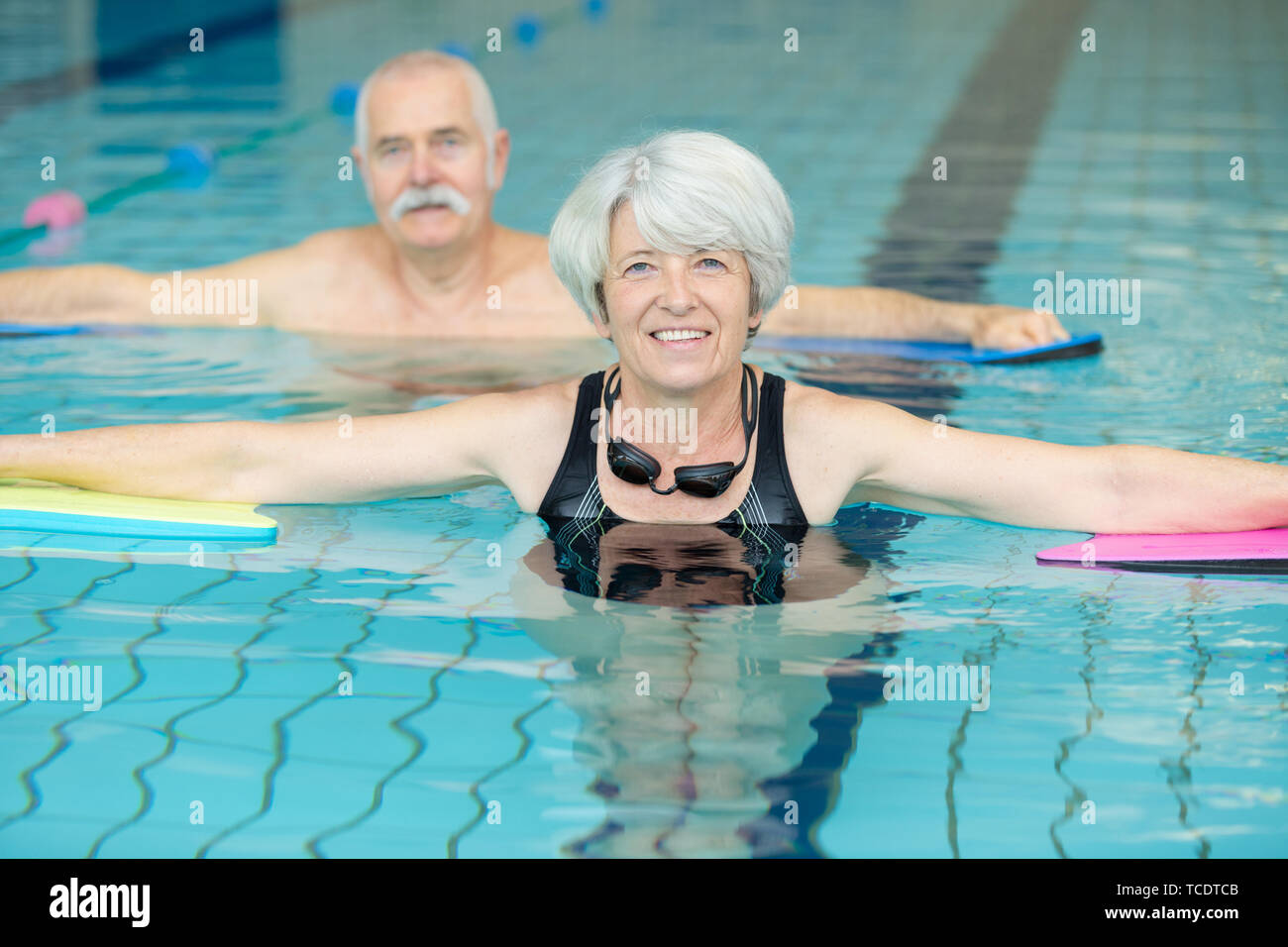 senior couple relaxing in swimming pool together Stock Photo - Alamy