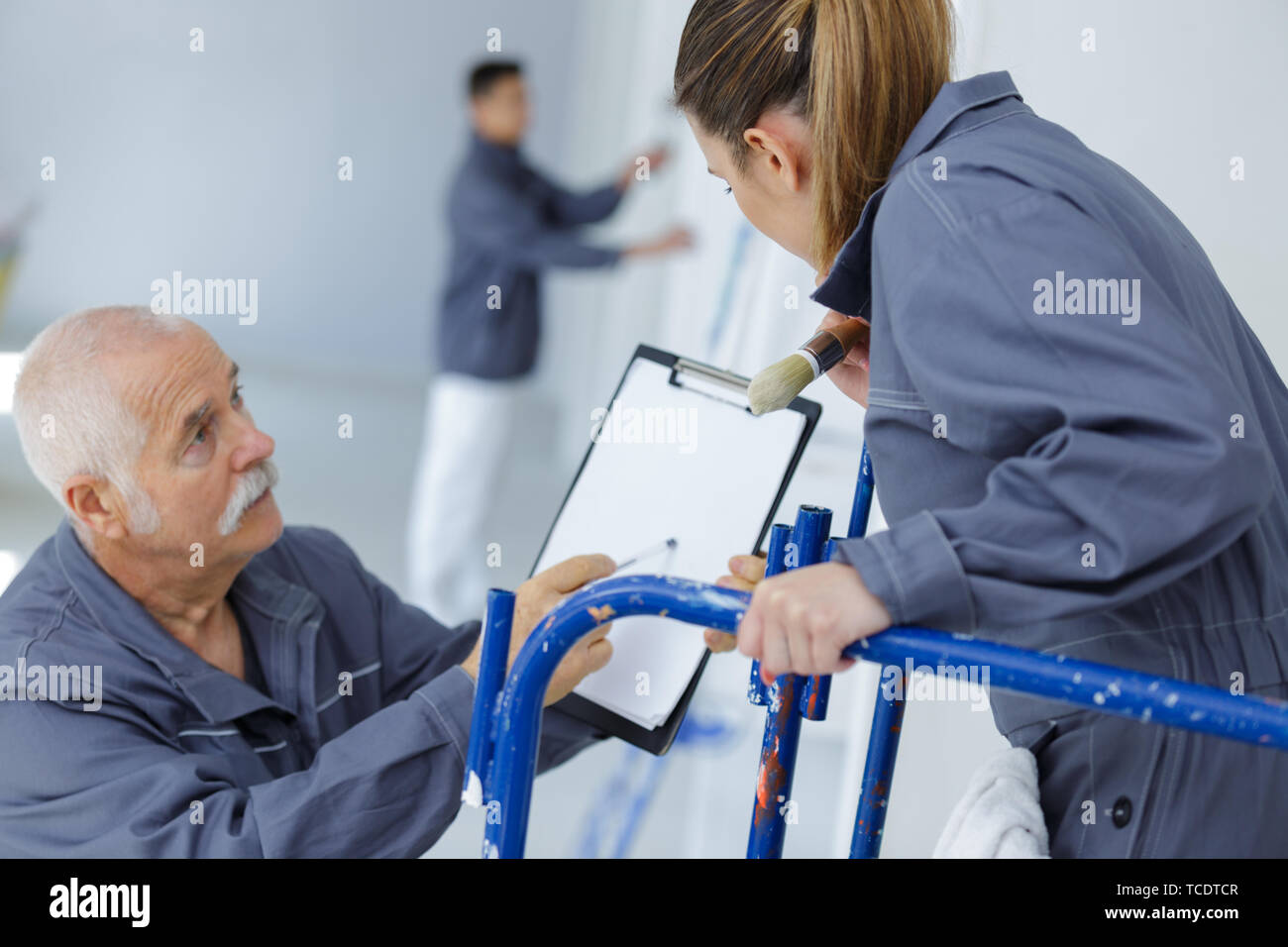 woman apprentice in front of painter Stock Photo