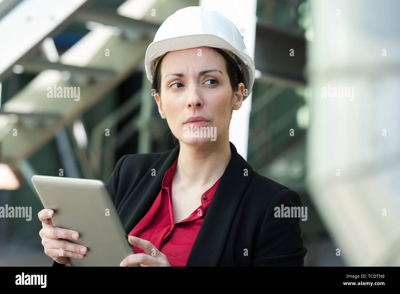 employee woman in suit standing in helmet with tablet Stock Photo - Alamy
