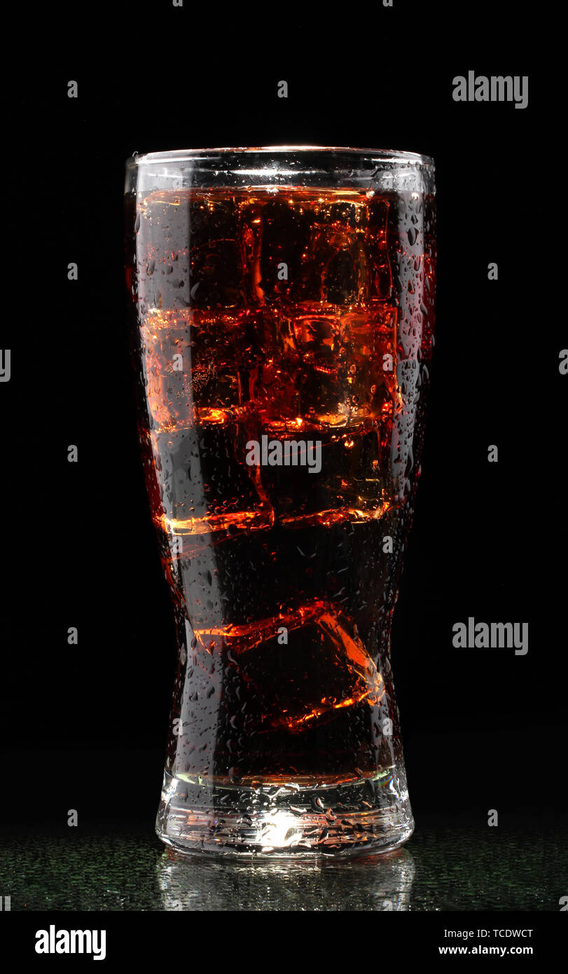 Glass of cola with ice on black background Stock Photo - Alamy