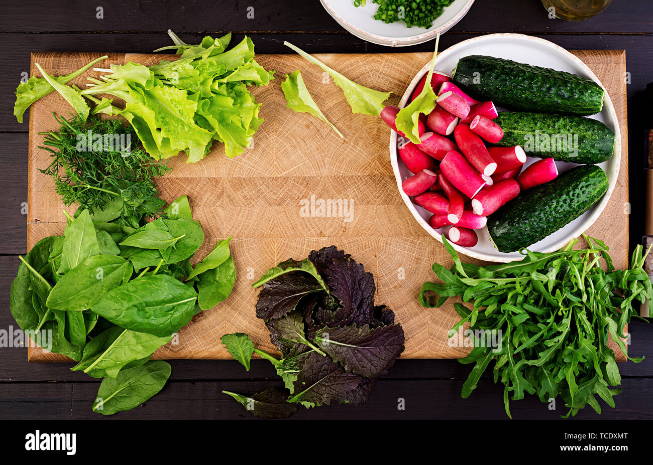 Ingredients for fresh salad of cucumbers, radishes and herbs. Flat lay. Top view Stock Photo