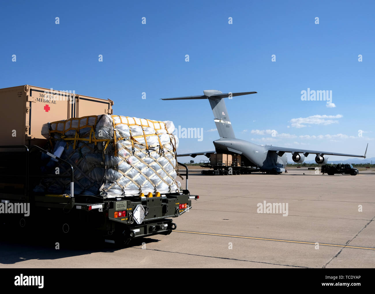 Individual Shipping Unit (ISU) and other palletized gear, is staged for loading on a cargo loader “K loader” which will be placed in a C-17 Globemaster III at Davis-Monthan Air Force Base, Ariz., June 1, 2019. The ISU contains medical equipment belonging to the 306th Rescue Squadron, which will be used for an upcoming deployment. The 306th Rescue Squadron’s mission is to rescue isolated personnel or equipment...anytime, anywhere. (U.S. Air Force photo by Andre Trinidad.) Stock Photo