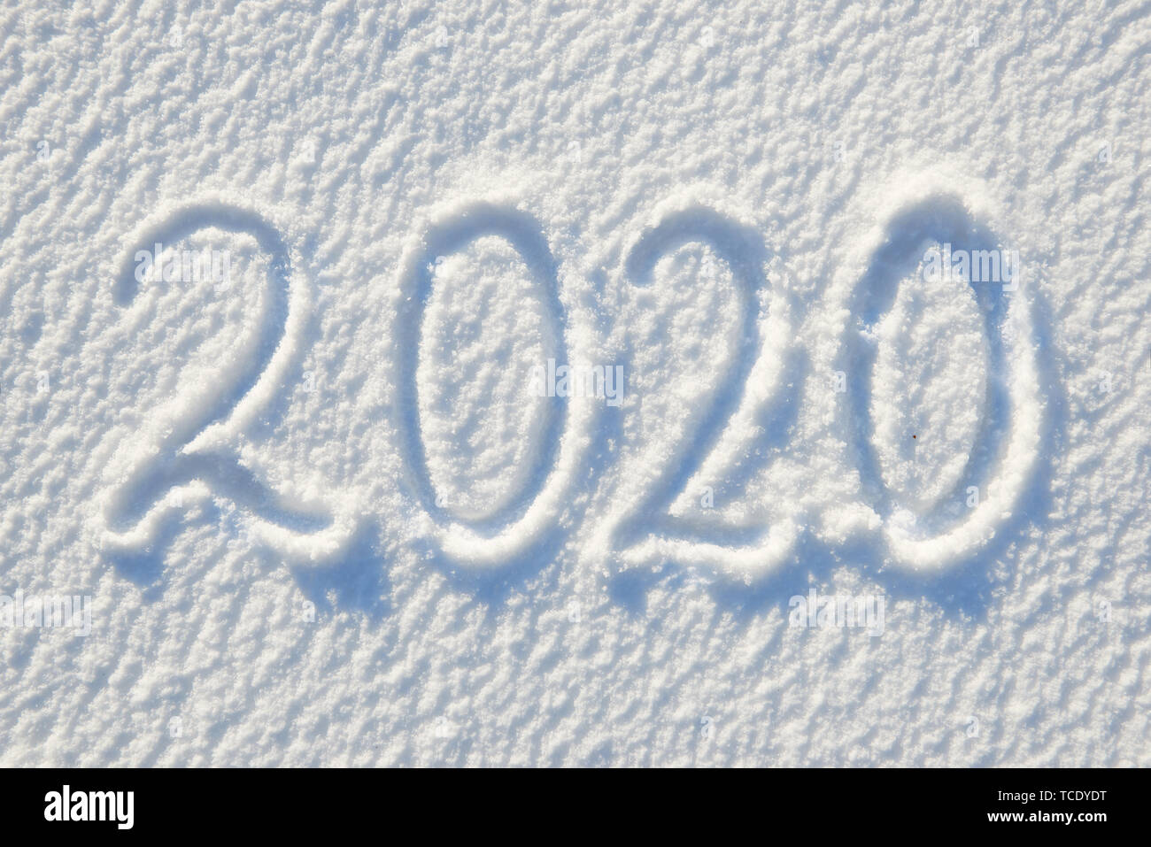 2020 text written on snow for texture or background - winter holiday concept Sunny day, bright light with shadows, flat lay, top view, clean and nobod Stock Photo