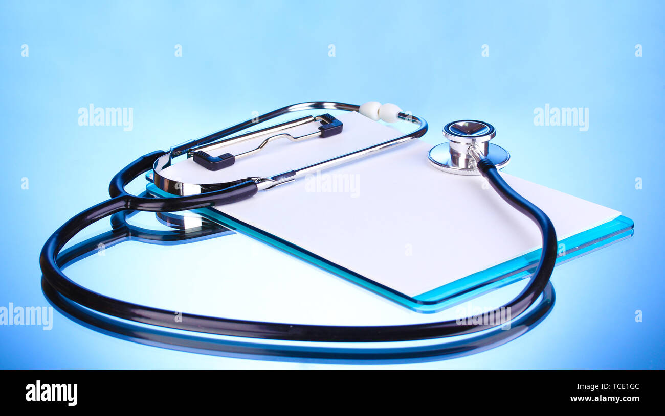 Medical stethoscope and clipboard on blue background Stock Photo - Alamy