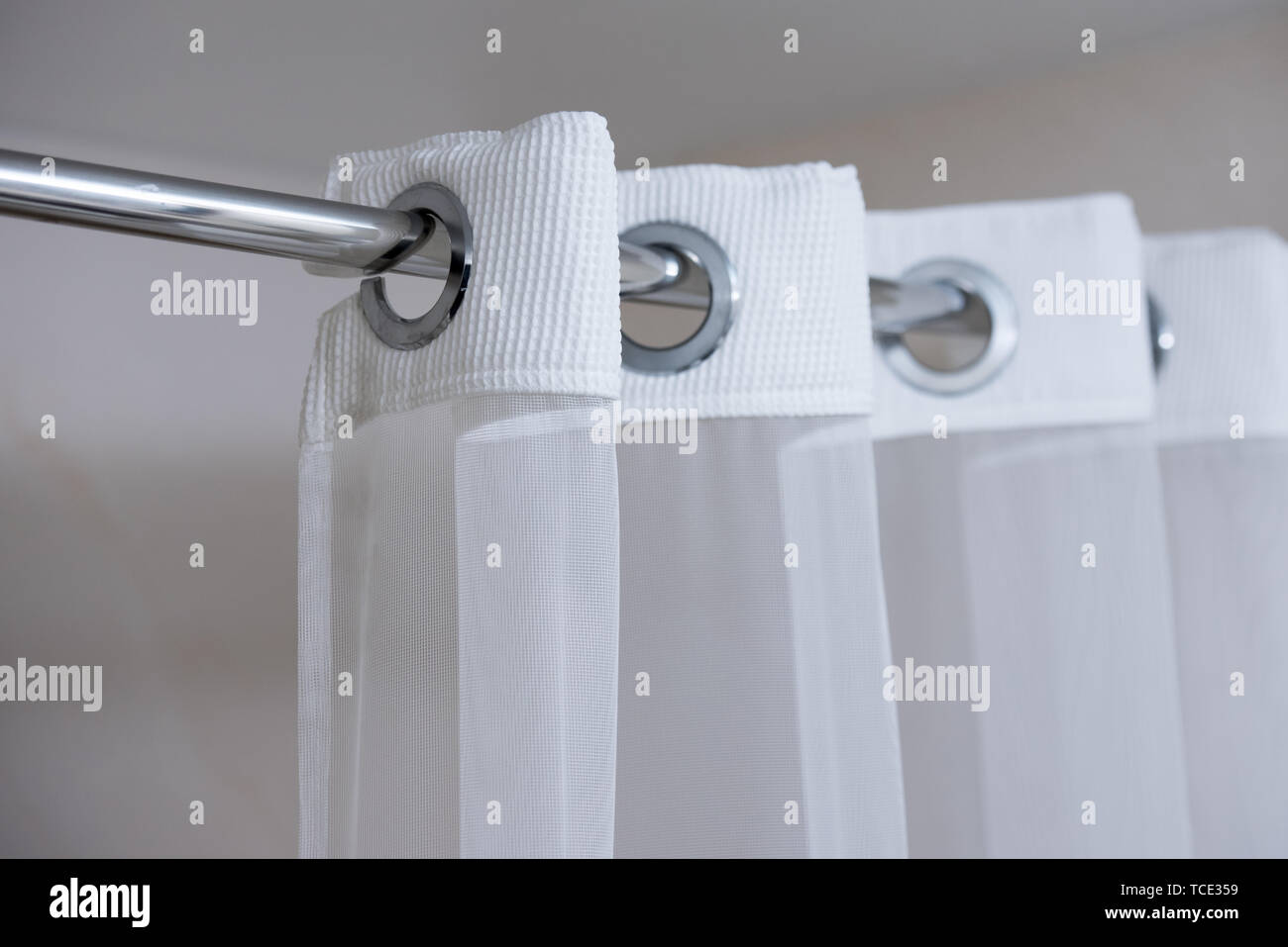 Shower Curtain Hanging From A Chrome Shower Curtain Rod Stock