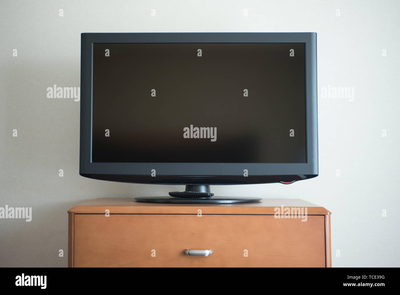 Flat Screen Tv Set On Top Of A Wood Dresser With Draw Stock Photo