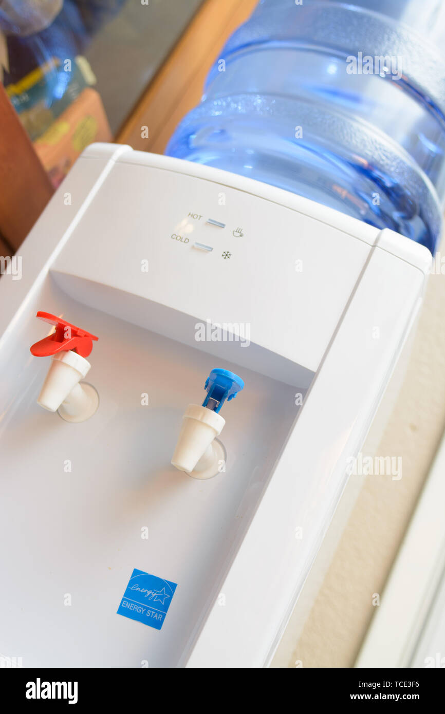 A water cooler with hot and cold spouts Stock Photo Alamy