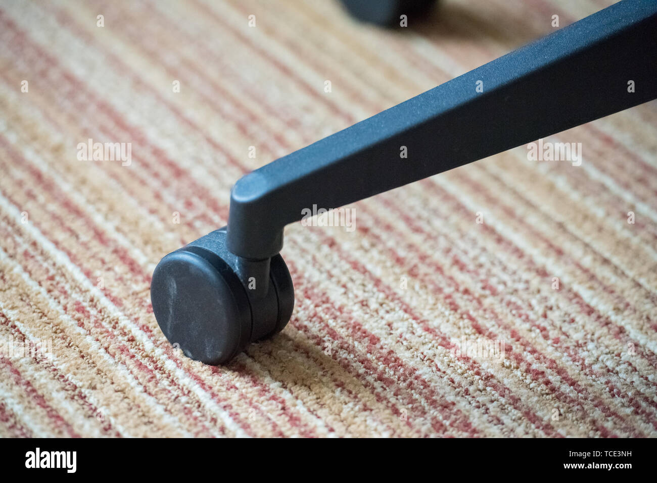 office chair wheel on carpet Stock Photo Alamy