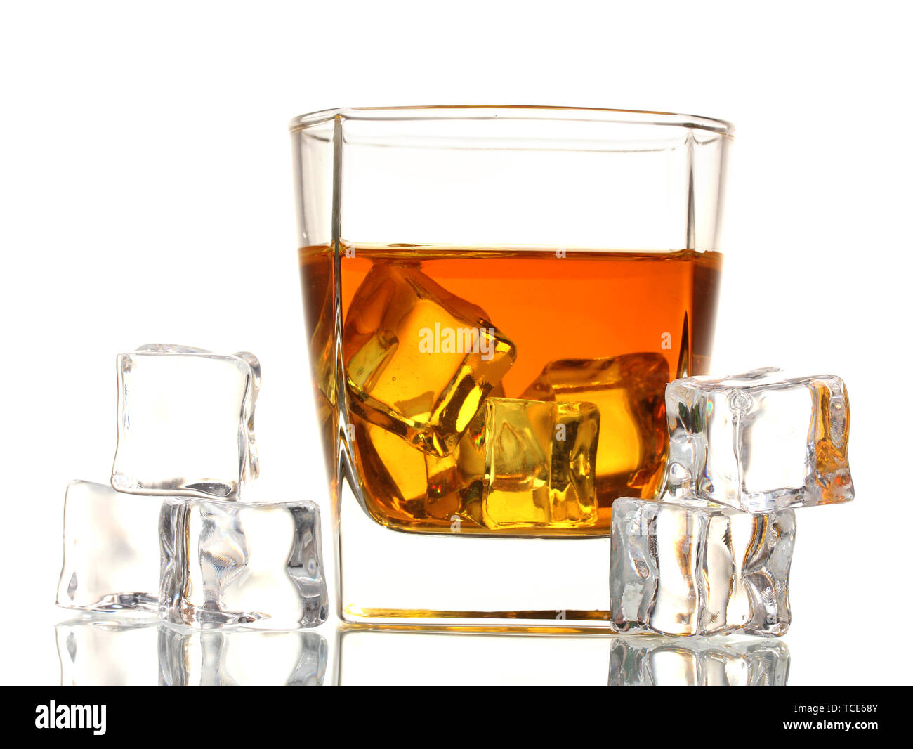 Glass of scotch whiskey and ice isolated on white Stock Photo - Alamy