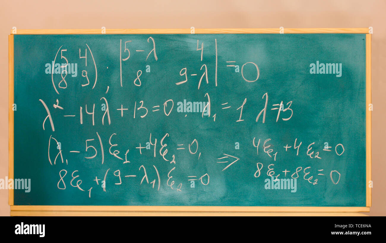 formulas written on green chalkboard Stock Photo