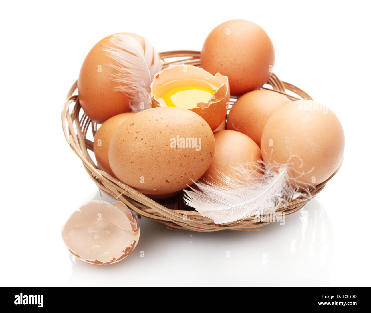 chicken eggs in a nest isolated on white Stock Photo - Alamy