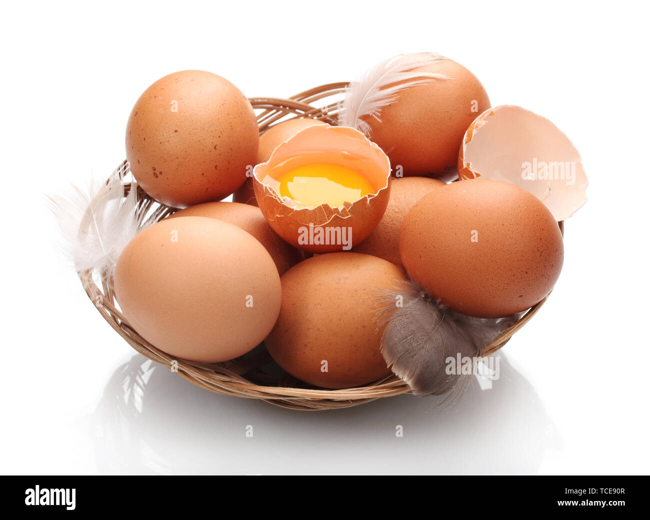 chicken eggs in a nest isolated on white Stock Photo - Alamy