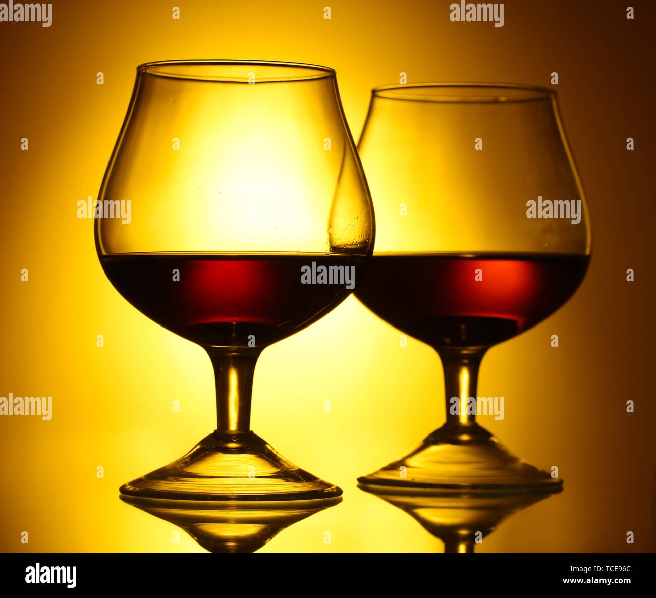 Download Two Glasses Of Cognac On Yellow Background Stock Photo Alamy PSD Mockup Templates