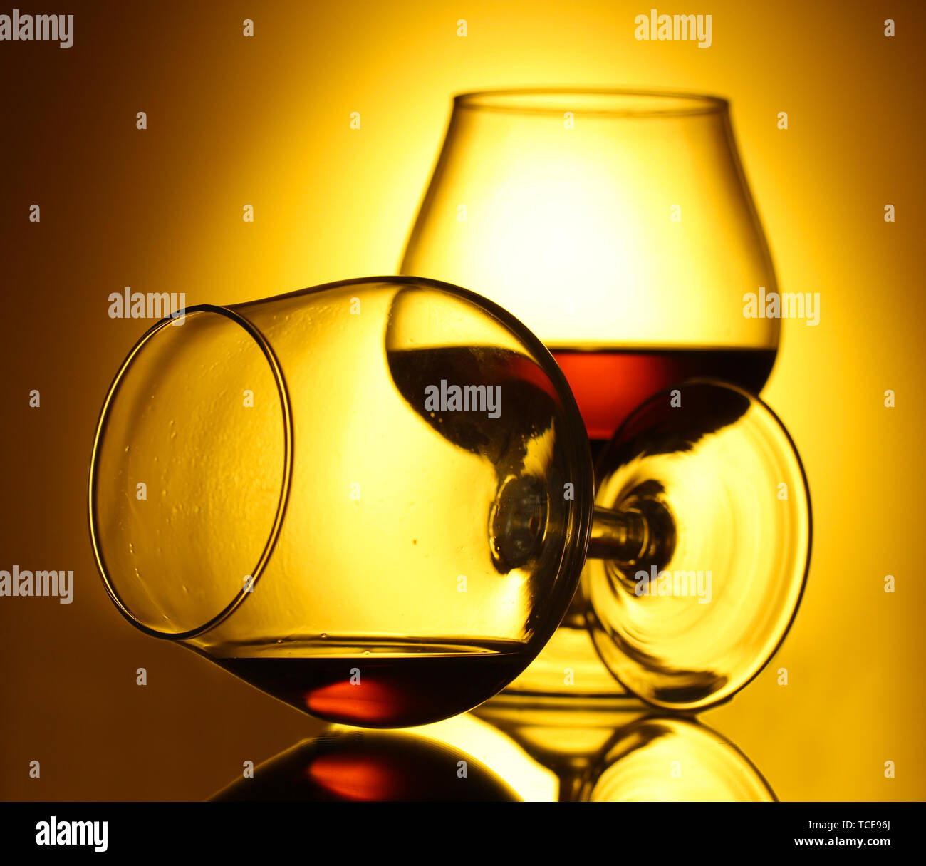 Download Two Glasses Of Cognac On Yellow Background Stock Photo Alamy Yellowimages Mockups
