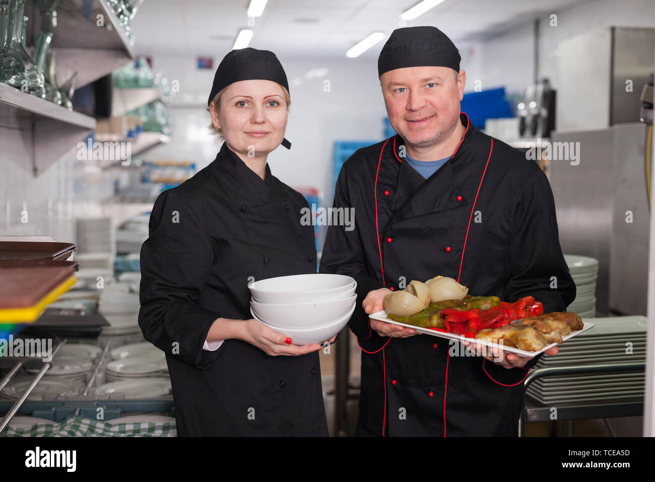 Female chef preparing dish team hi-res stock photography and images - Alamy