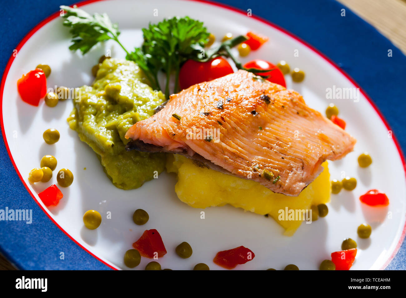 Fried trout fillet served with mashed potatoes and guacamole Stock Photo