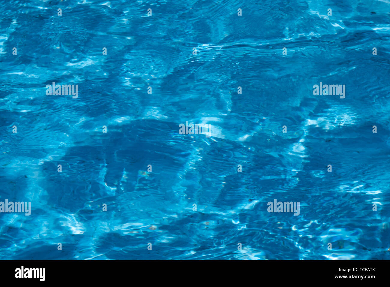 Blue and bright ripple clean water surface in swimming pool with sun ...