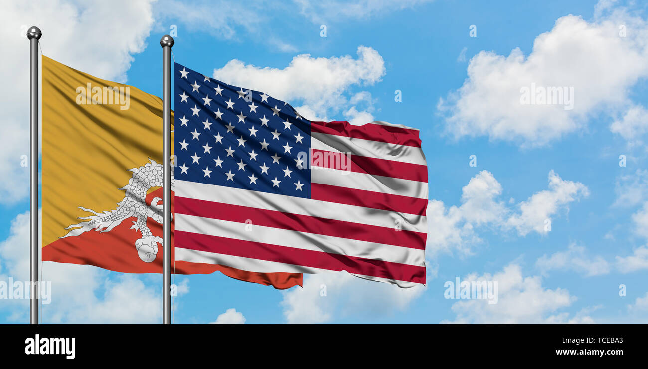 Bhutan and United States flag waving in the wind against white cloudy ...