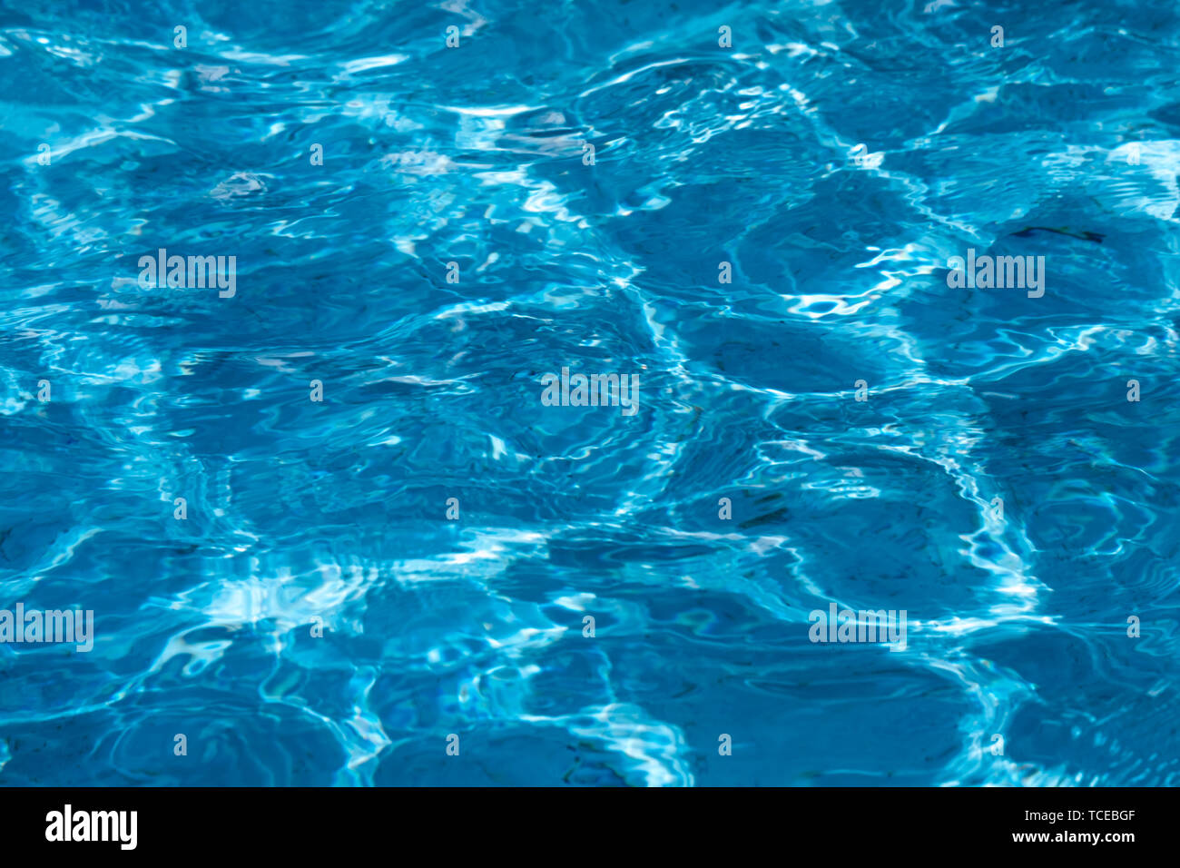 Blue and bright ripple clean water surface in swimming pool with sun ...