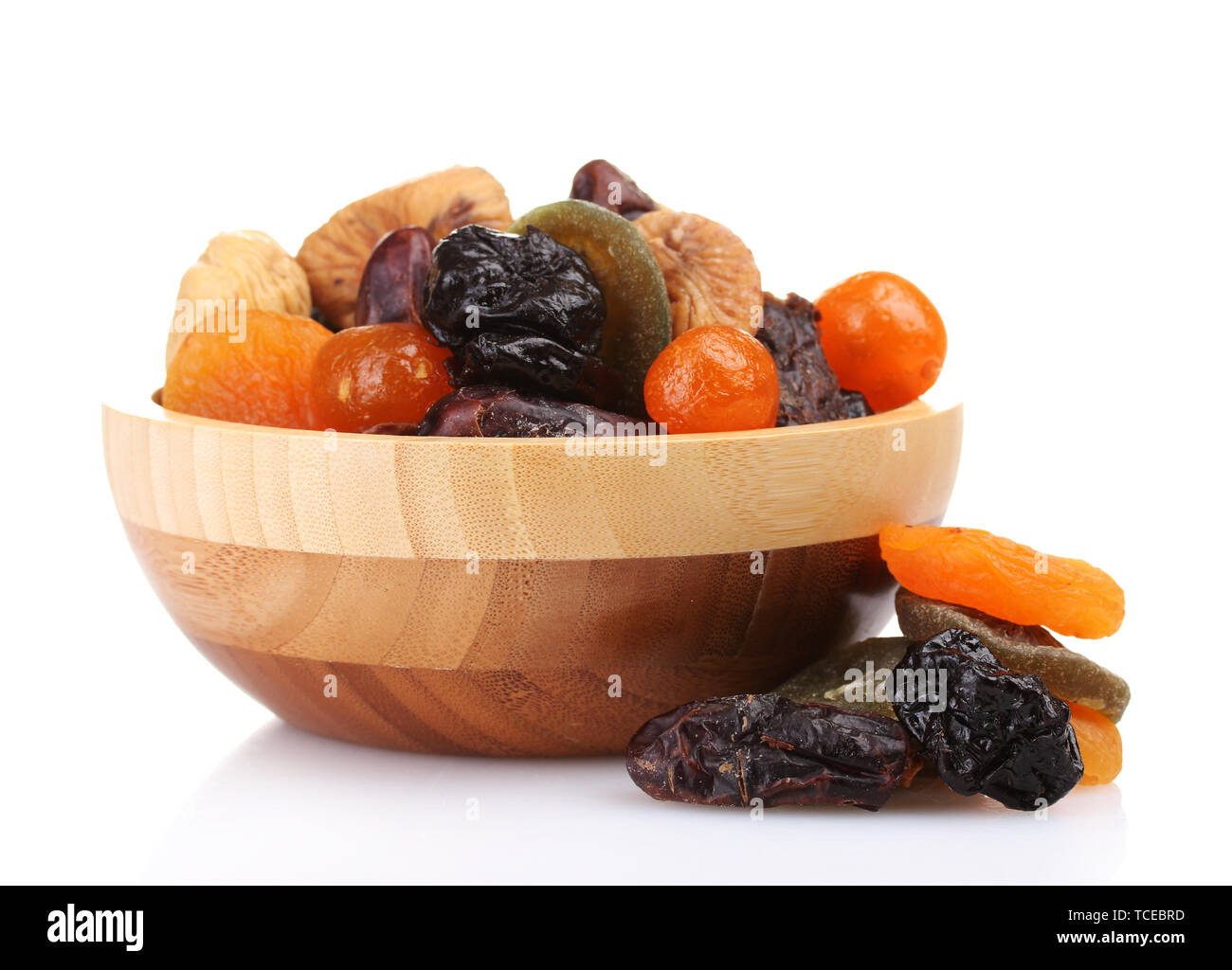 Dried fruits in wooden bowl isolated on white Stock Photo