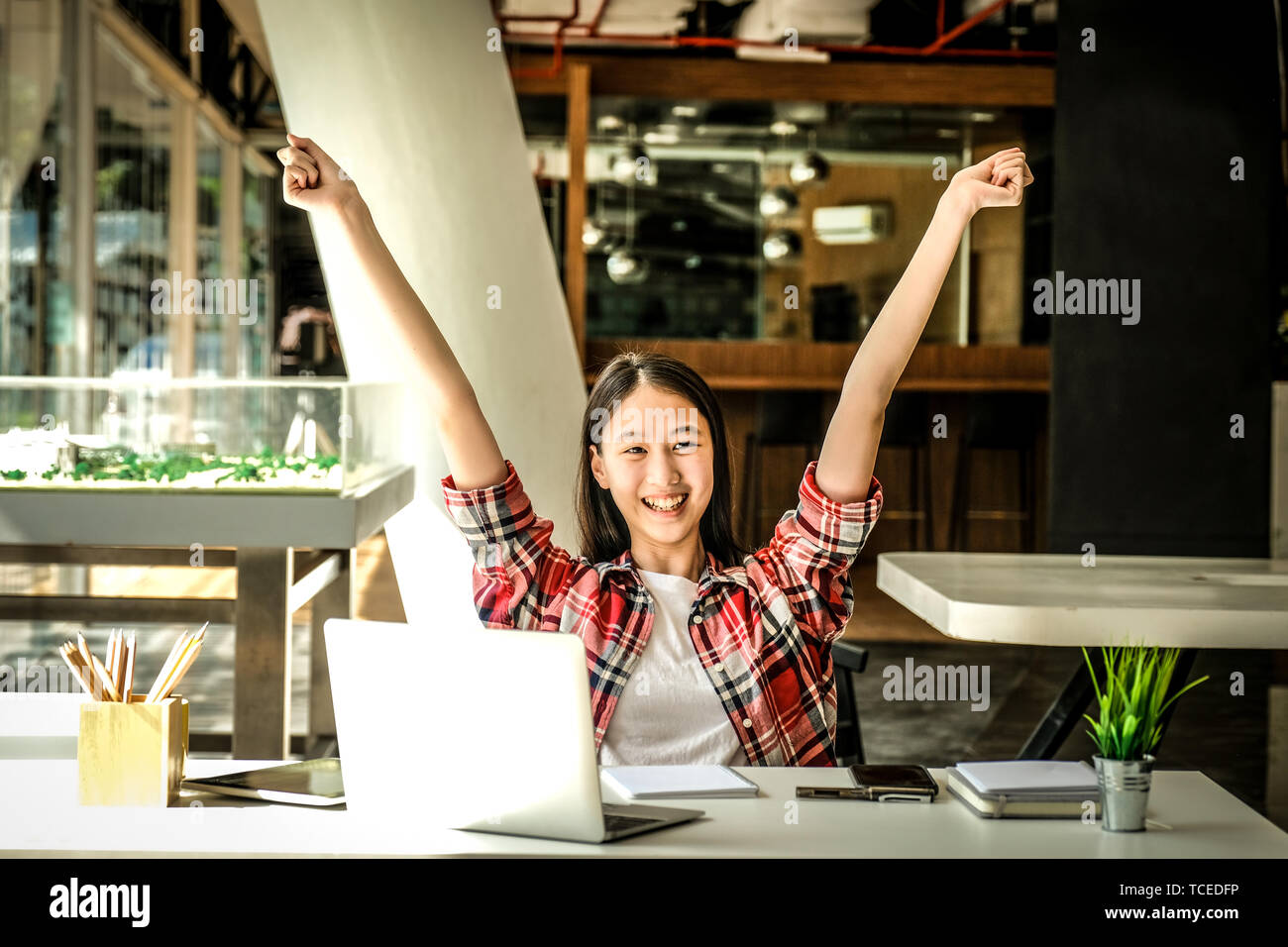 happy asian woman girl teenager raising hands with gladness happiness Stock Photo