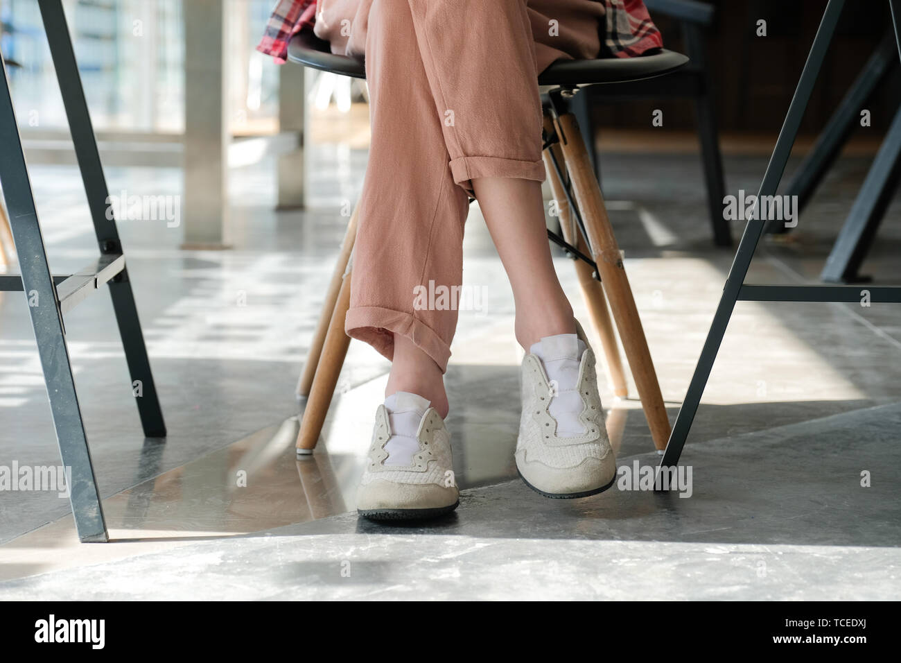 girl teenager friends legs wearing white sneakers sitting at cafe coffee  shop Stock Photo - Alamy