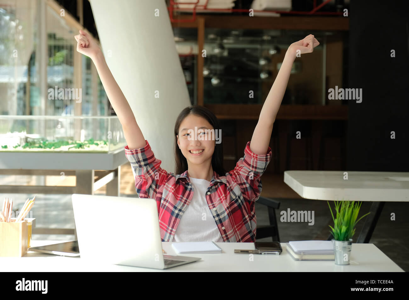 happy asian woman girl teenager raising hands with gladness happiness Stock Photo
