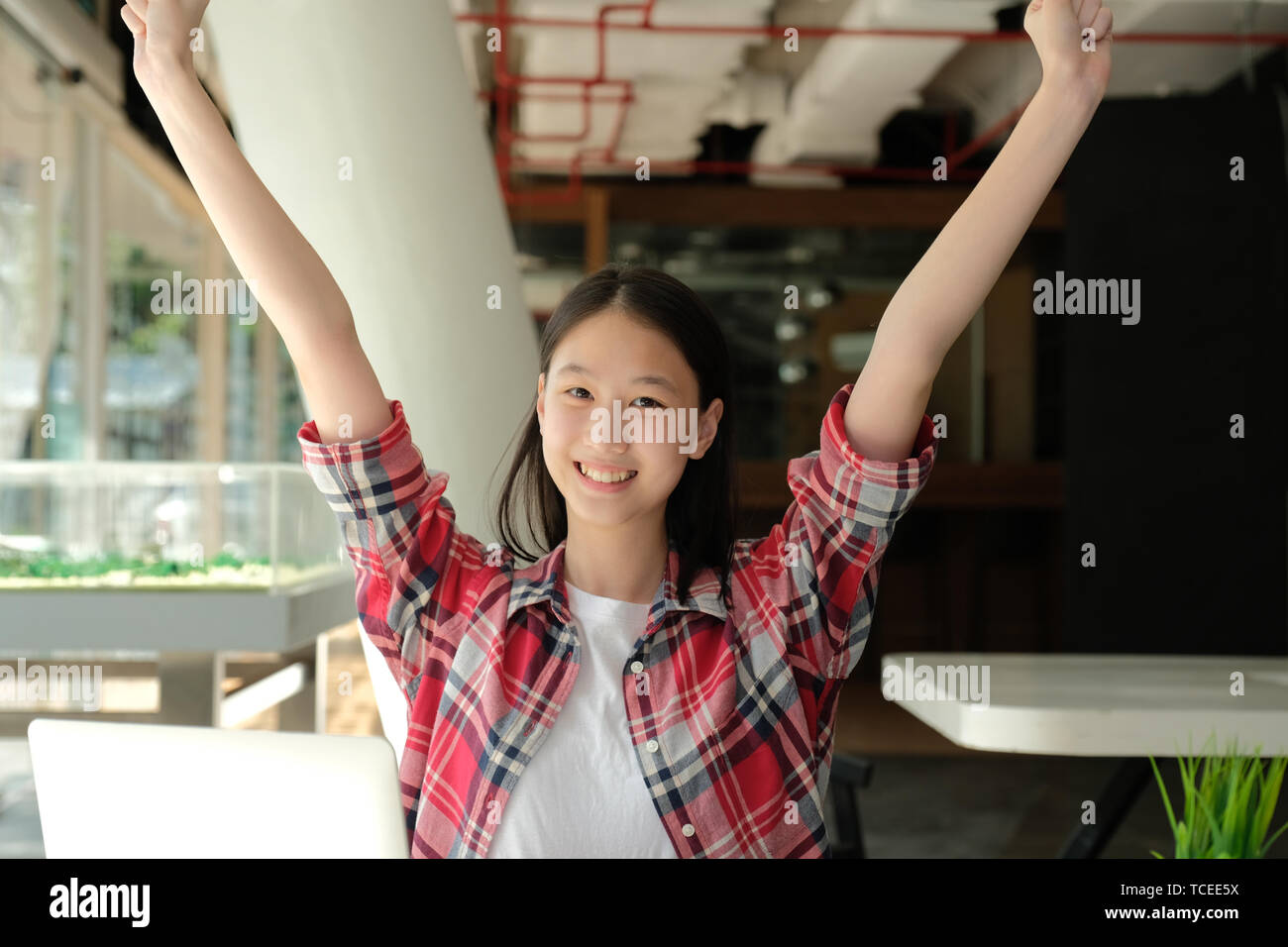 happy asian woman girl teenager raising hands with gladness happiness Stock Photo